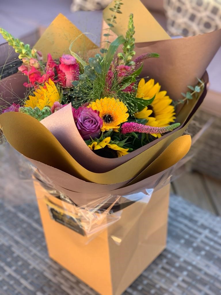 Hand Tied Bright Bouquet with Sunflowers, Hot Pink Roses and Snapdragons.